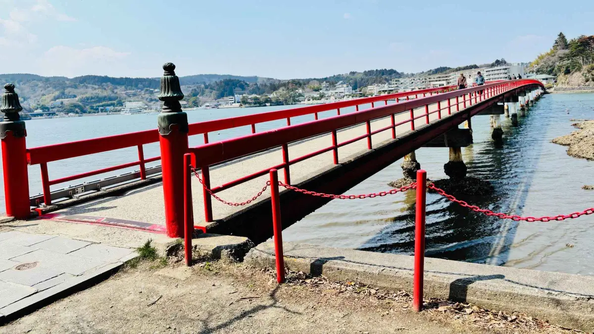The long red Fukuurabashi footbridge stretching out over the water to Fukuurajima island in Matsushima