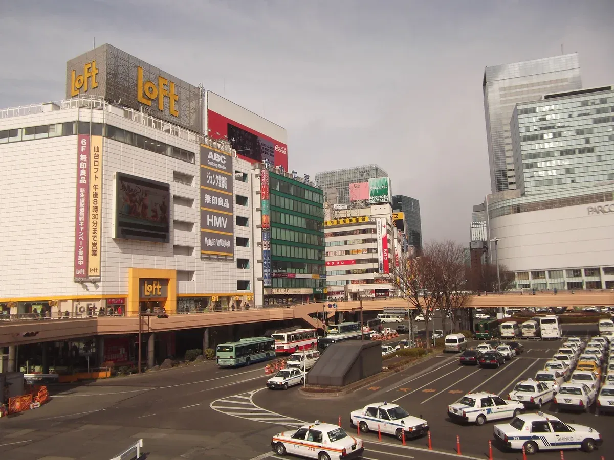 Sendai Station west side with department stores, a pedestrian deck above the bus and taxi pool